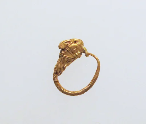 Gold earring with head of an animal