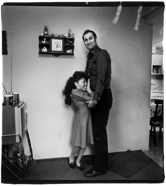 Couple in their living room hugging — Diane Arbus