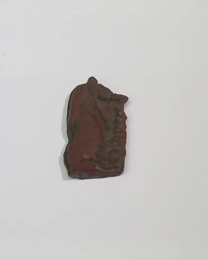 Mold-pressed amulet or fragment