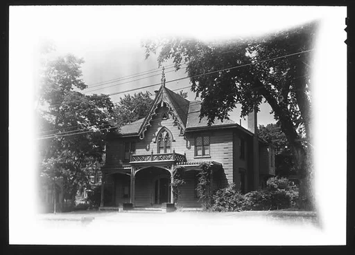 [Gothic Revival House with Decorative Vergeboard and Trefoil Window in Gable]