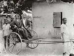 Two dapper young men in pull cart — Alex Agbaglo Acolatse