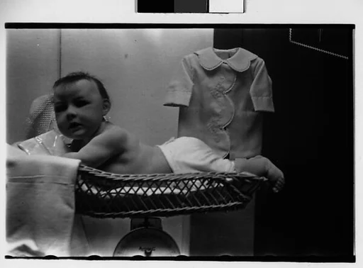 [Two 35mm Film Frames: Unidentified Baby in Basket on Scale]