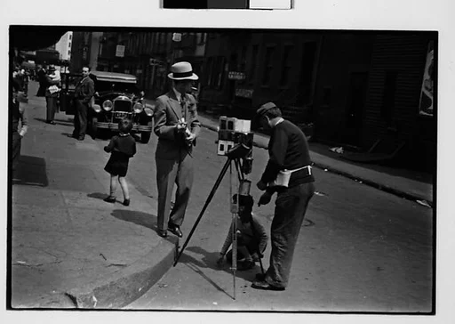 [Two 35mm Film Frames: Tintype Photographer and Man on Street Corner, New York City]