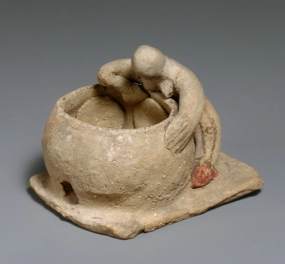 Terracotta woman baking bread — Unknown