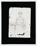 Woman in studio with headtie and dutch wax Victorian-style dress