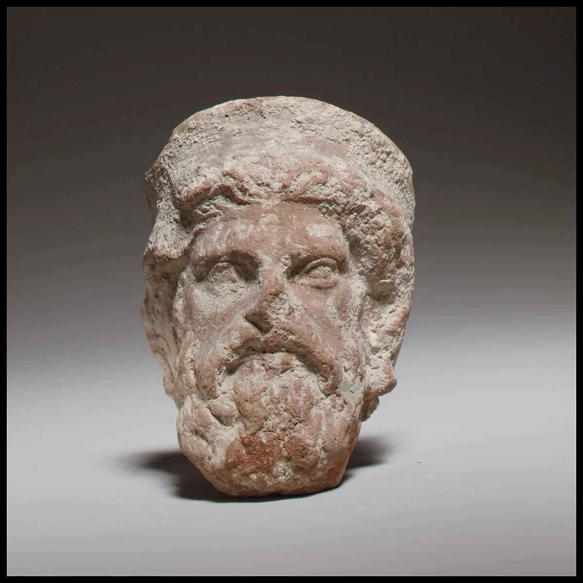 Terracotta head of a bearded god, perhaps Zeus — Unknown