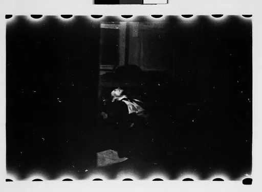 [Supine Man Through Doorway (Dark View)]