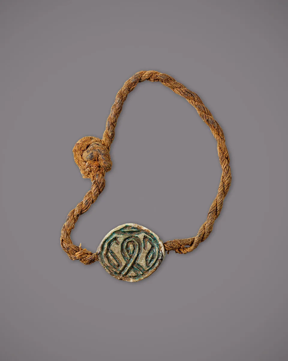 String Bracelet with a Cowroid Amulet — Unknown