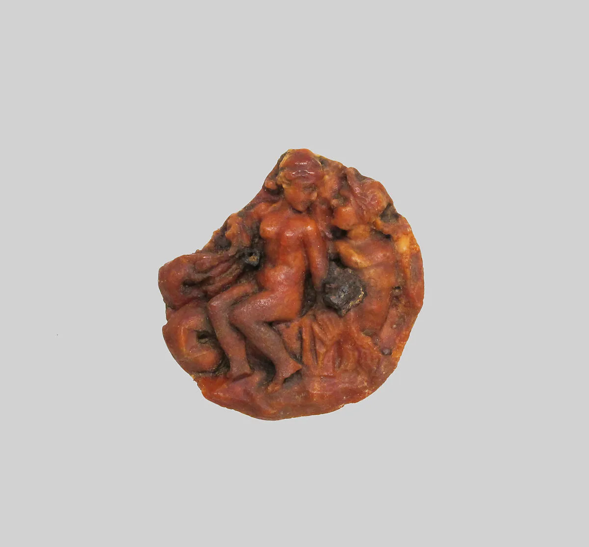 Amber disk with a nereid riding a triton — Unknown