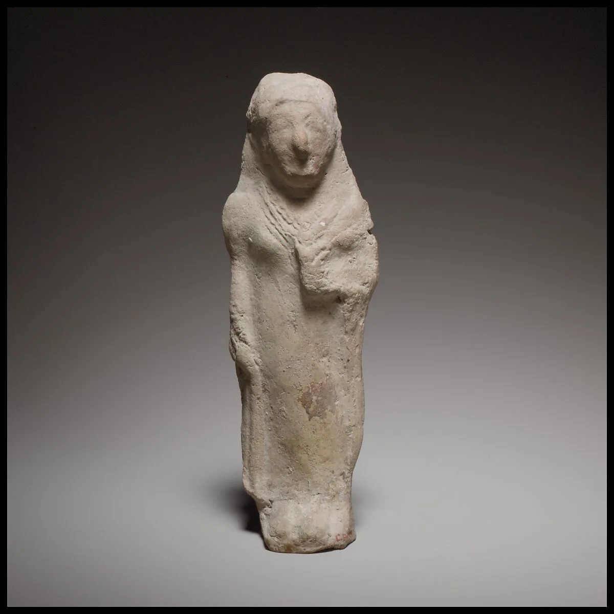 Standing female figurine holding a flower — Unknown