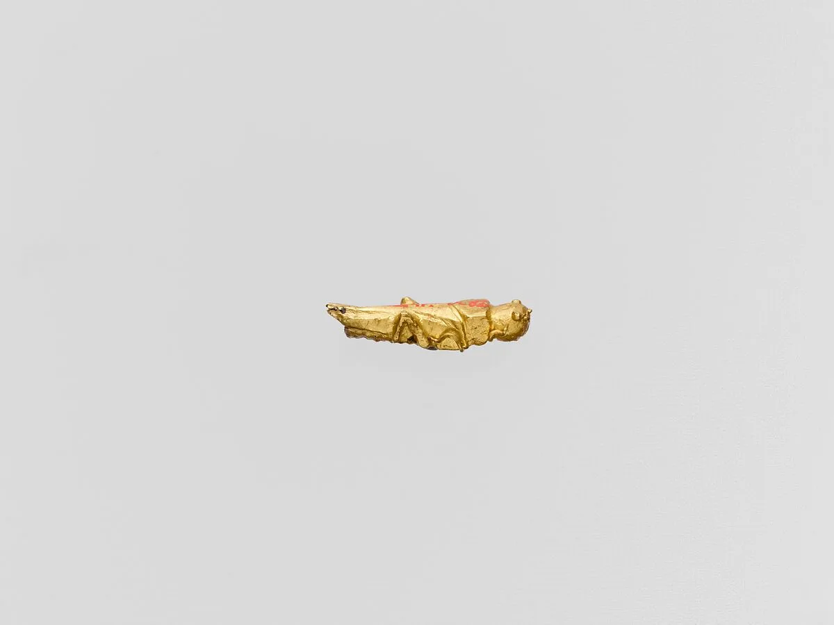 Gold capsule in the form of a grasshopper — Unknown