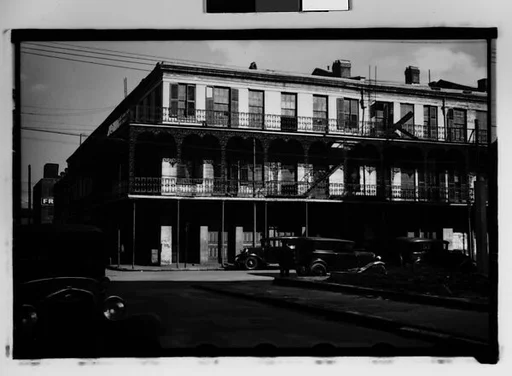 [Cast-Iron Balconied Houses with Parked Cars and Pedestrian on Street Corner, Mobile, Alabama]