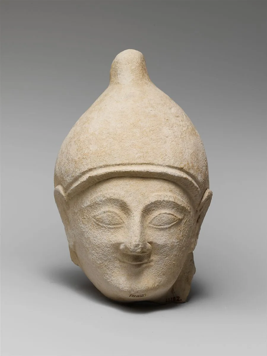 Limestone head of a man wearing a helmet — Unknown