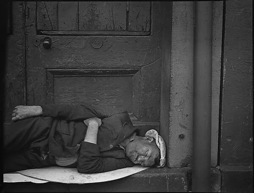 [Man Sleeping in Waterfront Doorway, New York City]