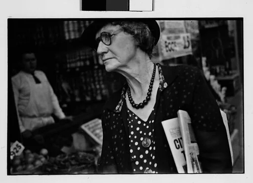 [Two 35mm Film Frames: Old Woman Outside Main Street Grocery Store, Ossining, New York]