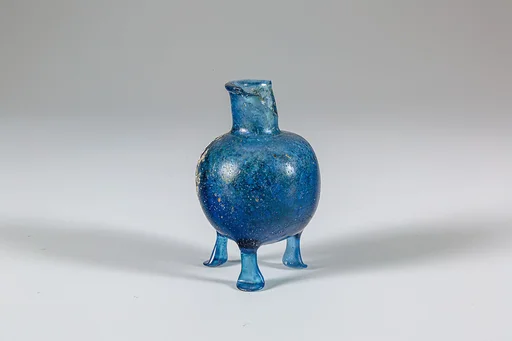 Glass bottle with three feet