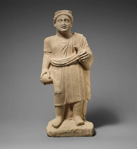 Limestone statuette of a boy with a wreath of leaves