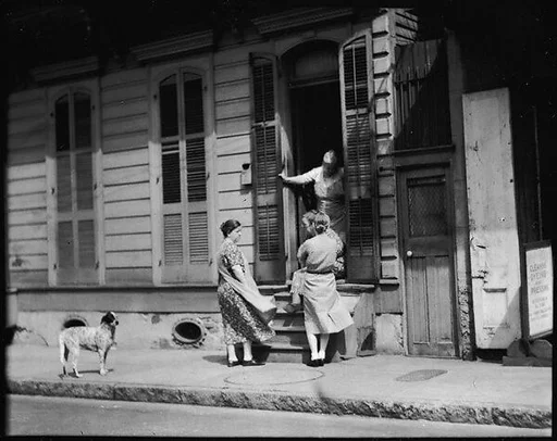[Women Talking Outside Shuttered House, New Orleans, Louisiana]