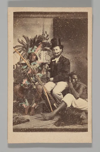 [Studio Portrait: Man Wearing Top Hat Seated with 2 Indigenous People]