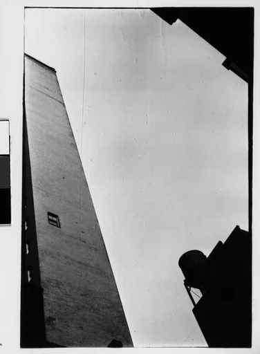 [Three 35mm Film Frames: Architectural Abstraction of Buildings and Watertower, From Below and Underexposed, Partial View of Bus Seat Backs with Advertisements, New York City]
