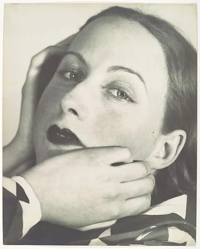 [Portrait Composition: Close-up, three-quarter view of woman with hands at her face]
