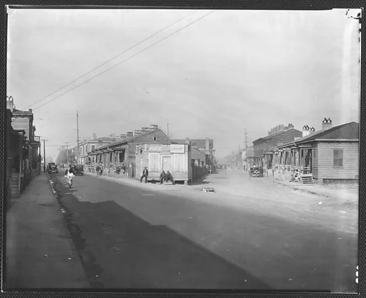 [Fork in Road with Two Rows of Wooden Houses and People on Corner, Savannah or Augusta, Georgia]