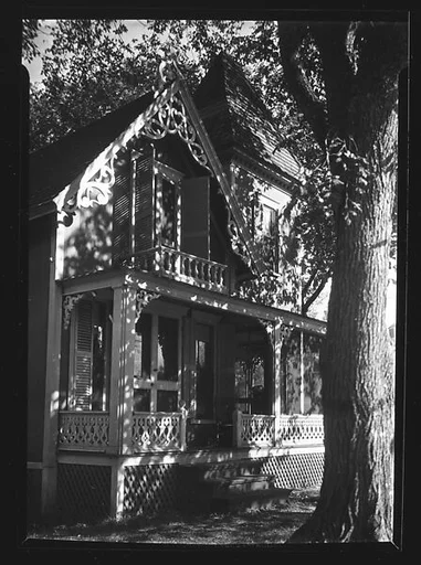 [Gingerbread Trim House With Tree in Foreground]