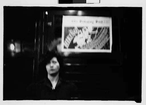 [Four 35mm Film Frames: Subway Passengers, New York City: Woman in Front of Transit Authority Poster, Man Reading Newspaper]