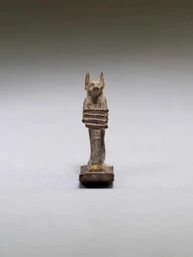 Anubis (?) supporting a large djed pillar