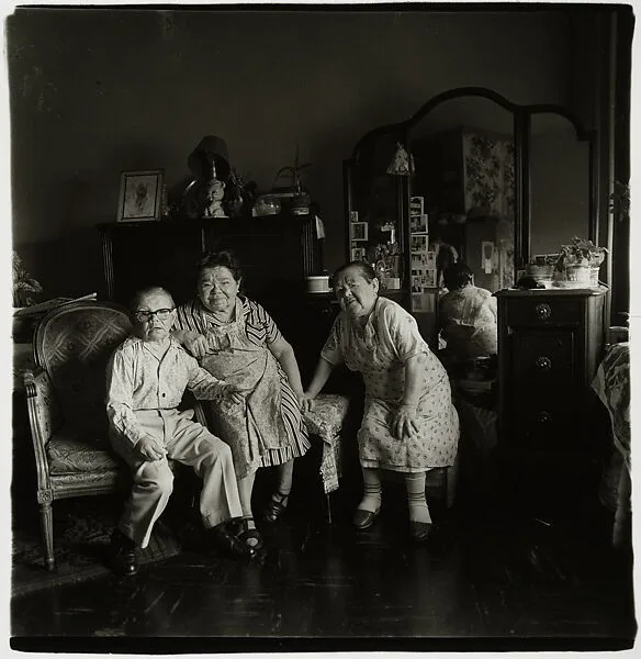 Russian midget friends in a living room on 100th Street, N.Y.C. — Diane Arbus