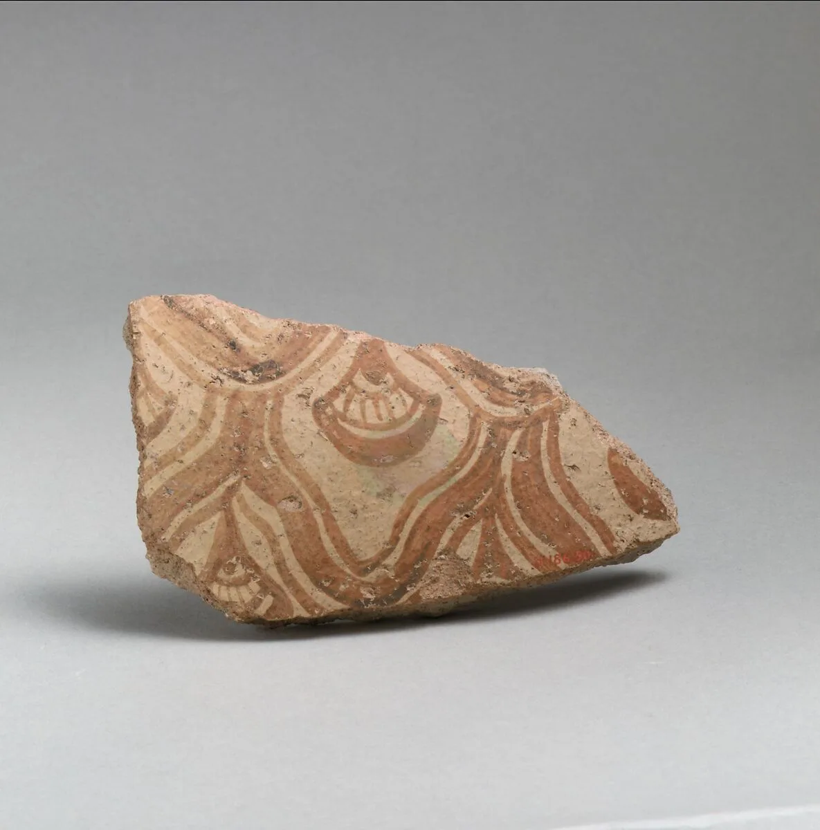 Two terracotta fragments of a large jar with reticulated pattern enclosing conventional flowers — Unknown