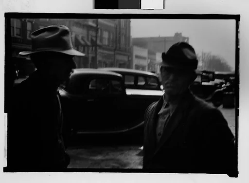 [Two Men in Front of Parked Cars, Milledgeville, Georgia]