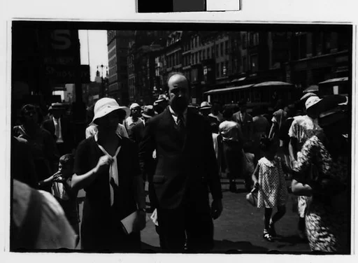 [Two 35mm Film Frames: Couple and Man with Sandwich Board Advertisement, Fourteenth Street, New York City]
