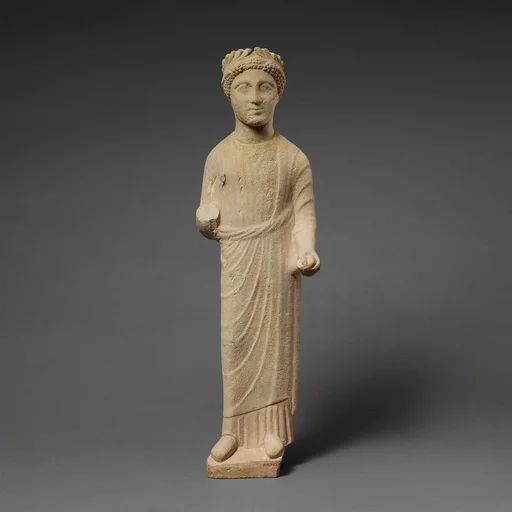Limestone statuette of a beardless male votary with a wreath of leaves