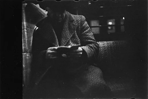 [Five 35mm Film Frames: Subway Passengers, New York City: Man Reading, Man in Suit]