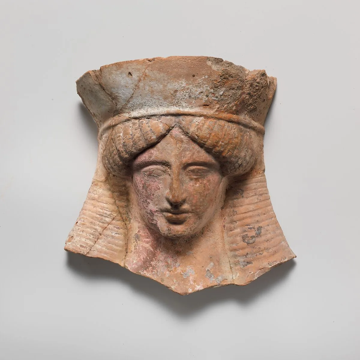 Terracotta relief head of a woman — Unknown