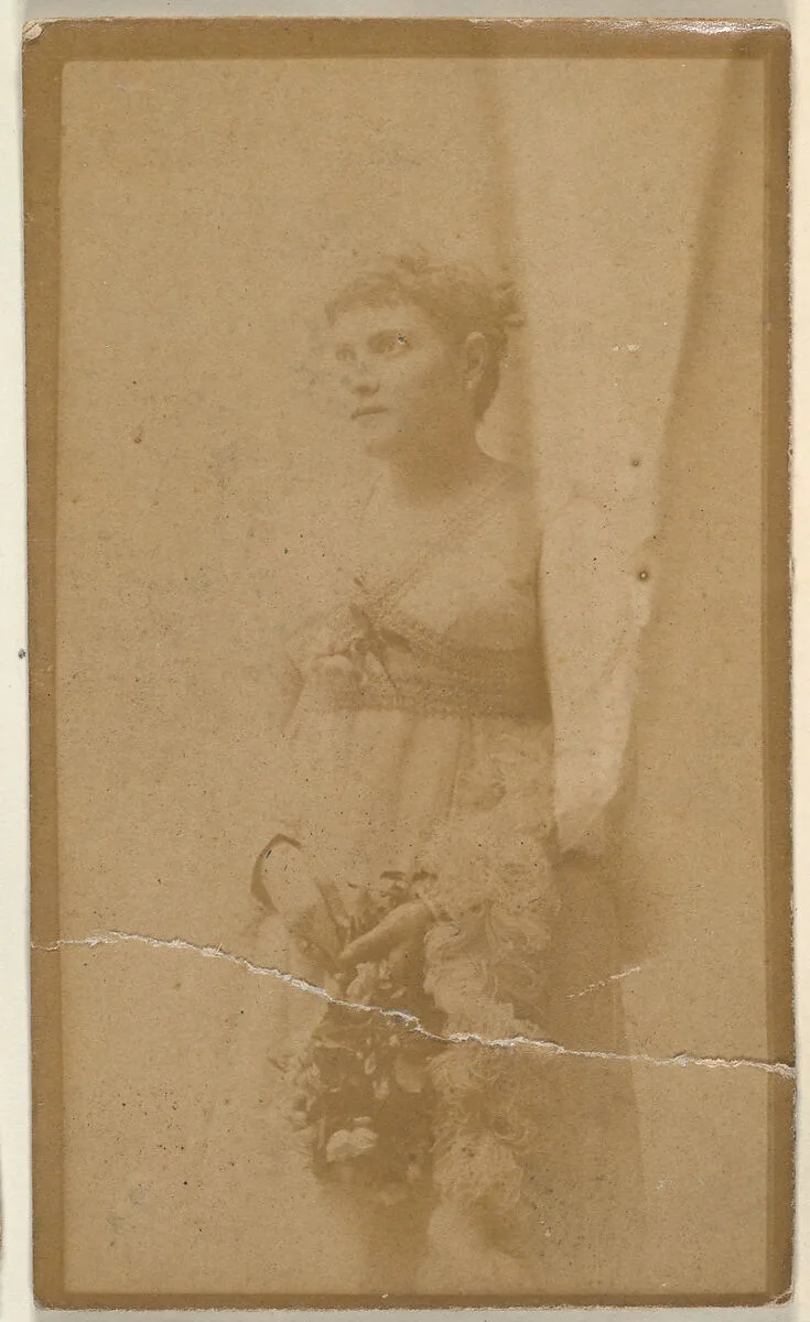 Actress holding headpiece of floral vines, from the Actresses series (N668) — Unknown