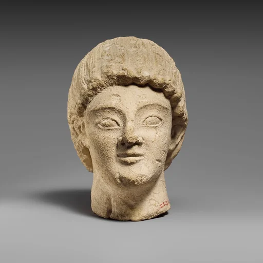 Limestone head of a beardless male votary
