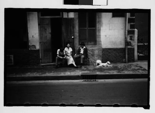 [People Seated on Sidewalk in French Quarter, New Orleans, Louisiana]