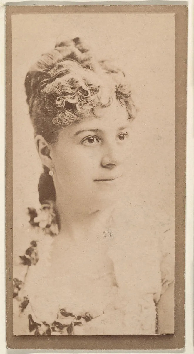 Actress wearing dress with floral neckline, from the Actresses series (N668) — Unknown