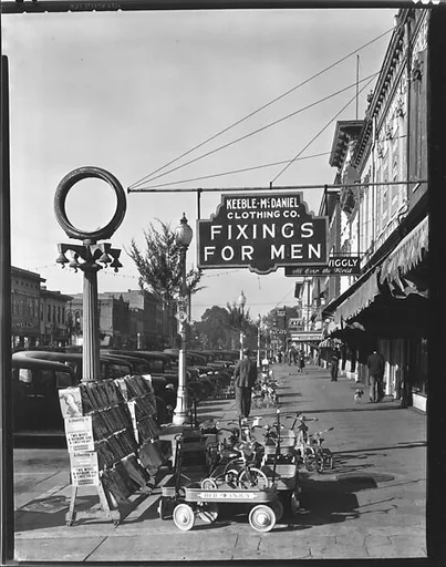 [Sidewalk Scene with Keeble-McDaniel Clothing Company Sign, Main Street, Selma, Alabama]