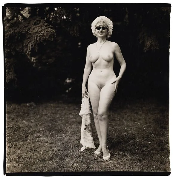 Nudist lady with swan sunglasses, Pa. — Diane Arbus