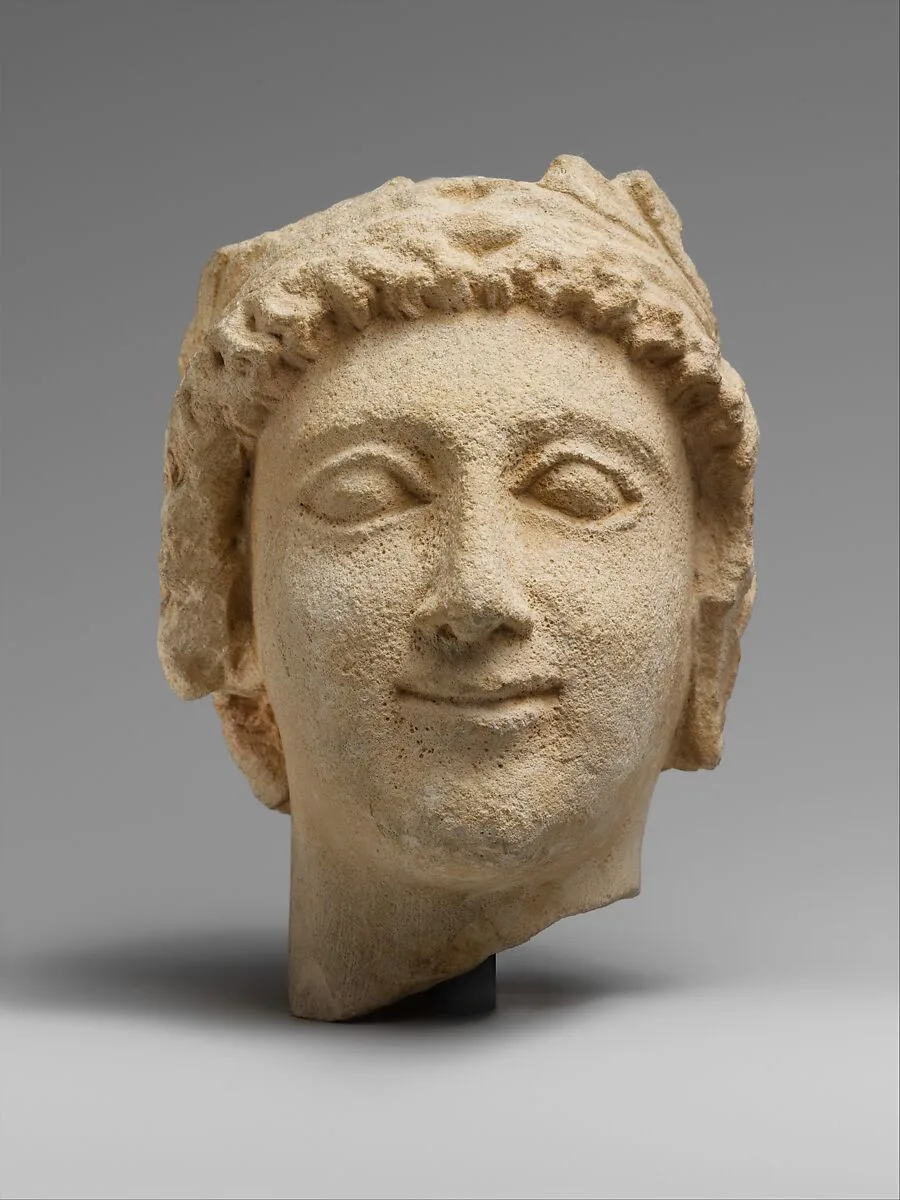 Limestone head of a wreathed youth — Unknown