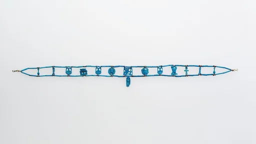 Necklace restrung with amulets and a faience cartouche bead of Tutankhamun
