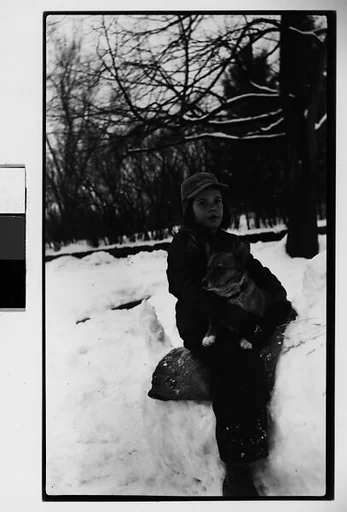 [Child, Possibly Mabry Girl, Holding Dog in Snow]