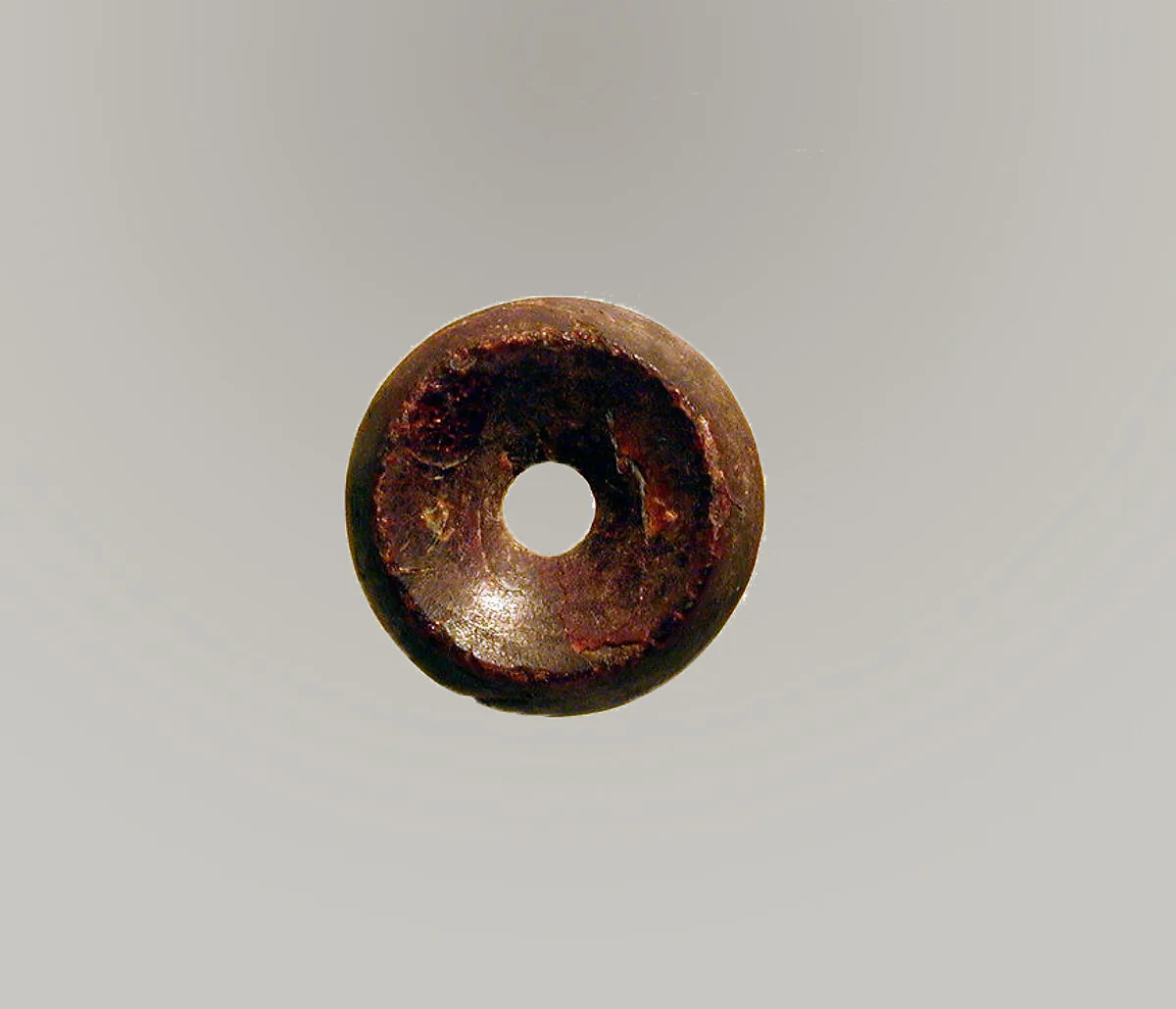 Pierced disk, perhaps from an earring or fibula (safety pin) — Unknown