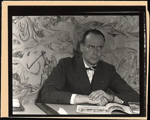 [Lincoln Kirstein Seated Behind Desk, for Fortune Article "The Boom in Ballet"]