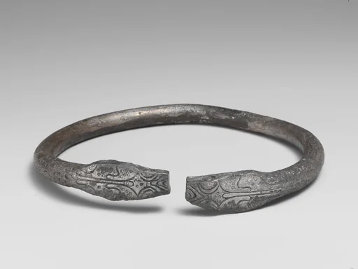 Pair of silver bracelets ending in snake's heads