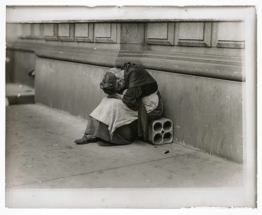 [Woman Sitting on City Sidewalk with Head in Hands]