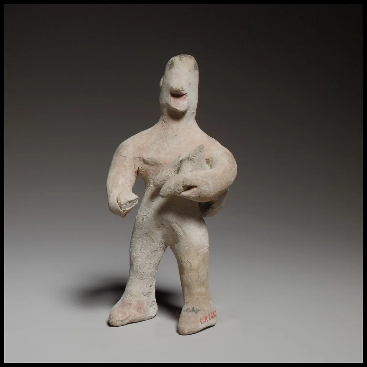 Standing male figurine holding a quadruped — Unknown